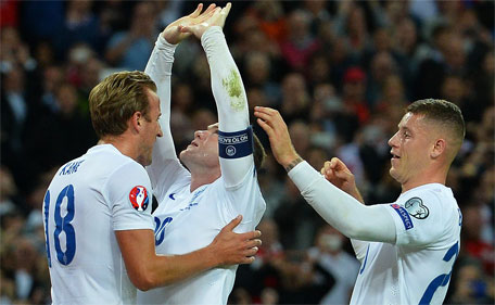 England's striker Wayne Rooney (centre) celebrates with Harry Kane (left) and Ross Barkley after scoring from the penalty spot, his 50th goal for England, making him the country's all-time goal scorer, during the Euro 2016 qualifying group E football match between England and Switzerland at Wembley Stadium in west London on September 8, 2015.    (AFP)