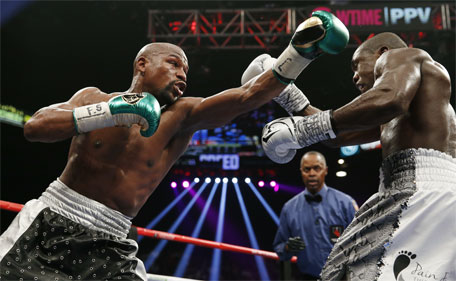 Floyd Mayweather Jr. (left) throws a left at Andre Berto during their welterweight title boxing bout Saturday, Sept. 12, 2015, in Las Vegas. (AP)