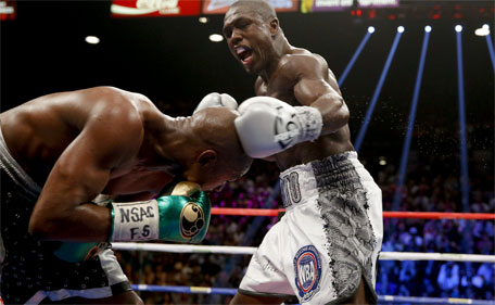 Andre Berto (right) punches Floyd Mayweather Jr. during their welterweight title fight Saturday, Sept. 12, 2015, in Las Vegas. (AP)