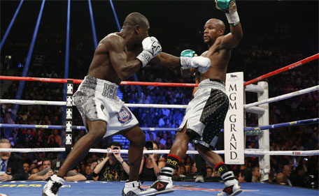 Floyd Mayweather Jr.  (right) dodges a punch from Andre Berto during their welterweight title boxing bout Saturday, Sept. 12, 2015, in Las Vegas. (AP)