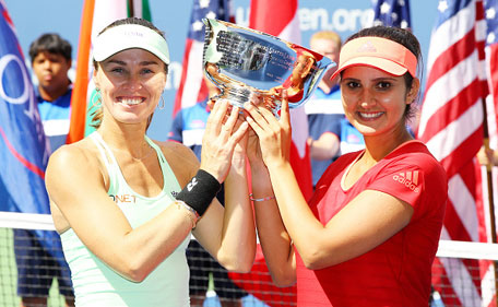 Martina Hingis (left) of Switzerland and Sania Mirza of India celebrate with the winner's trophy after defeating Casey Dellacqua of Australia and Yaroslava Shvedova of Kazakhstan after their Women's Doubles Final on Day Fourteen of the 2015 US Open at the USTA Billie Jean King National Tennis Center on September 13, 2015 in the Flushing neighborhood of the Queens borough of New York City. (Getty)