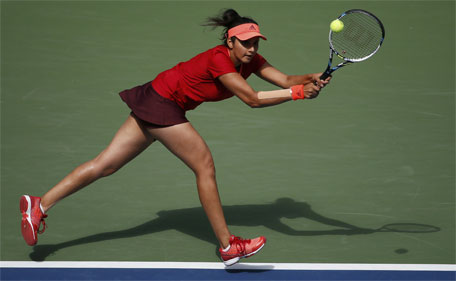 Sania Mirza of India chases down a return with playing partner Martina Hingis of Switzerland (not pictured) as they face Casey Dellacqua of Australia and Yaroslava Shvedova of Kazakhstan in the women's doubles final match at the U.S. Open Championships tennis tournament in New York, September 13, 2015. (Reuters)