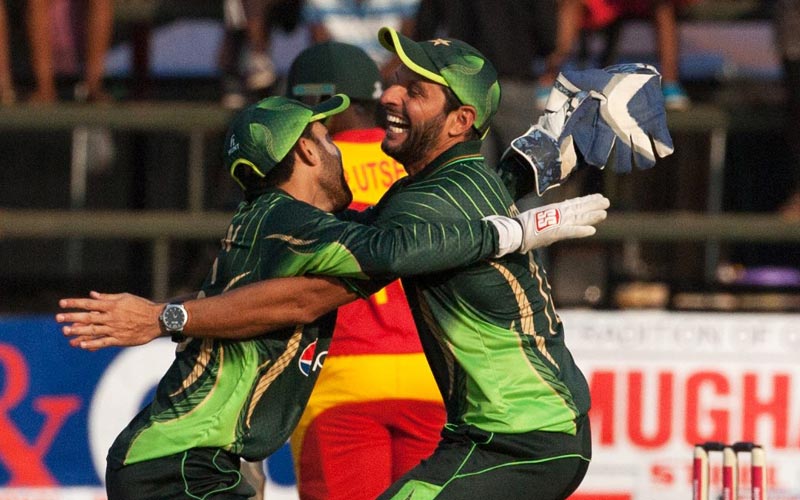 Pakistan's captain Shahid Afridi (R) celebrates a wicket with wicket keeper Muhammad Rizwan (L) during the first of two T20 cricket matches between Pakistan and hosts Zimbabwe at the Harare Sports Club on September 27, 2015. Pakistan defeated Zimbabwe by 13 runs. AFP