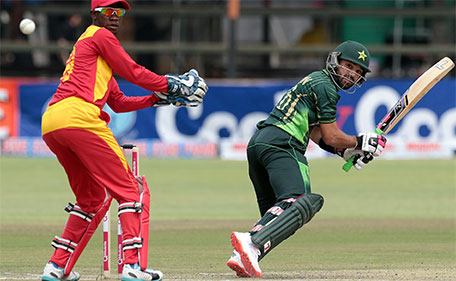 Pakistan's batsman Muhammad Rizwan (right) prepares to play a shot next to Zimbabwe's wicketkeeper Richmond Mutumbami during the second of two T20 cricket matches between Zimbabwe and Pakistan at Harare Sports Club on September 29, 2015. (AFP)