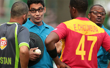 Sri Lanka's umpire Ruchira Palliyaguruge (second left) and Zimbabwe's umpire Jeremiah Matibiri (right) consult with Pakistan's captain Azhar Ali (left) and Zimbabwe's captain Elton Chigumbura, as Zimbabwe were awarded victory under Duckworth Lewis because of bad light during the second game in a series of three ODI cricket matches between Pakistan and hosts Zimbabwe at the Harare Sports Club on October 3, 2015. (AFP)