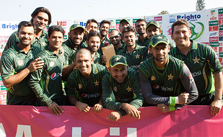 Pakistan's players celebrate with the series trophy after their victory in the final game in a series of three ODI cricket matches between Pakistan and hosts Zimbabwe at the Harare Sports Club on October 5, 2015. (AFP)