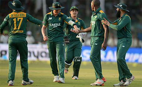 South Africa's captain AB de Villiers (L) celebrates with teammates Hashim Amla (R) Kagiso Rabada (2R) wicketkeeper Quinton de Kock (centre) and Dale Steyn (second left) celebrate after Rabada took the wicket of India's captain Mahendra Singh Dhoni during the first one day international between India and South Africa at Green Park Stadium in Kanpur on October 11, 2015. (AFP)