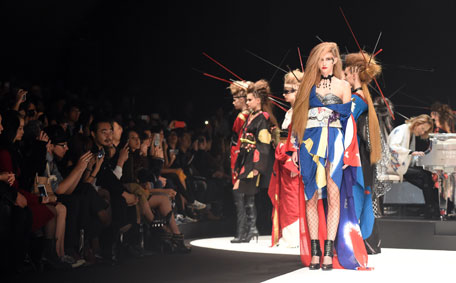 Models display creations by Japanese rock star and kimono designer Yoshiki (R) at the YOSHIKIMONO first collection during the finale of Tokyo Fashion Week in Tokyo on October 17, 2015. (AFP)