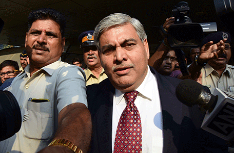 Board of Control for Cricket in India (BCCI) president Shashank Manohar is escorted out of the Indian cricket board's headquarters at the Wankhede stadium in Mumbai on October 19, 2015. Dozens of activists stormed the Mumbai offices of India's cricket board on October 19 to disrupt planned talks on resuming matches against Pakistan, the latest protest by hardline Hindu activists in the city.    AFP