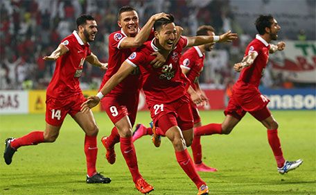 Kwon Kyung-Won (centre) of UAE's Al Ahli celebrates after scoring a third goal against Saudi's Al Hilal during their AFC Champions League semi final match on October 20, 2015 in Dubai. (AFP)