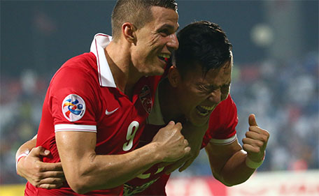 Kwon Kyung-Won (right) of UAE's Al Ahli celebrates after scoring a third goal against Saudi's Al Hilal during their AFC Champions League semi final match on October 20, 2015 in Dubai. (AFP)