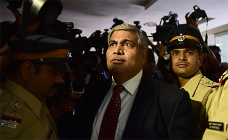 Board of Control for Cricket in India (BCCI) president Shashank Manohar is escorted out of the Indian cricket board's headquarters at the Wankhede stadium in Mumbai on October 19, 2015. (AFP)