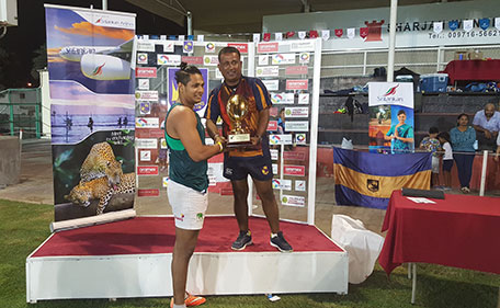 Isipathana captain Dulanka Gunasekera receiving the championship trophy from Roger Rodrigo at the 11th Lanka Lions Inter-School Tag Rugby Sevens tournament on October 23. (SHAFRAZ IBRAHIM)