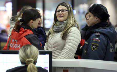A woman reacts next to Russian Emergencies Ministry members at Pulkovo airport in St. Petersburg, Russia, October 31, 2015. A Russian airliner carrying 224 passengers and crew crashed in Egypt's Sinai peninsula on Saturday, the Egyptian civil aviation authority said, and a security officer who arrived at the scene said most of the passengers appeared to have died. The Airbus A-321, operated by Russian airline Kogalymavia with the flight number 7K9268, was flying from the Sinai Red Sea resort of Sharm el-Sheikh to St Petersburg in Russia when it went down in a desolate mountainous area of central Sinai soon after daybreak, the aviation ministry said.  (Reuters)