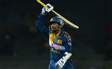 Sri Lanka's Tillakaratne Dilshan raises his bat to the crowd after scoring a half-century during the first One Day Internationa between Sri Lanka and the West Indies at the R. Premadasa Stadium in Colombo on November 1, 2015. (AFP)