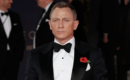 British actor Daniel Craig poses on arrival for the world premiere of the new James Bond film 'Spectre' at the Royal Albert Hall in London on October 26, 2015. The film is directed by Sam Mendes and sees Daniel Craig play suave MI6 spy 007 for a fourth time. (AFP)