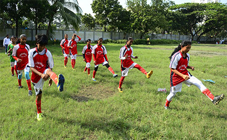 In this photograph taken on September 14, 2015, young Bangladeshi girls from Kolsindur high school football team stretch before a match in Dhaka. (AFP)