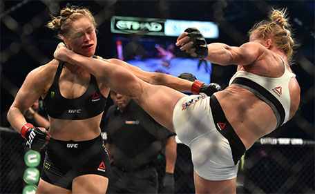Holly Holm (right)  of the US lands a kick to the neck to knock out compatriot Ronda Rousey and win the UFC title fight in Melbourne on November 15, 2015. (AFP)