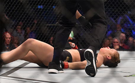 Ronda Rousey of the US hits the canvas after being knocked out by compatriot Holly Holm by a kick to the neck to end the UFC title fight in Melbourne on November 15, 2015. (AFP)
