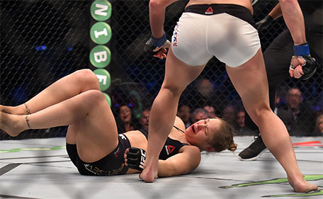 Ronda Rousey of the US hits the canvas after being knocked out by compatriot Holly Holm by a kick to the neck to end the UFC title fight in Melbourne on November 15, 2015. (AFP)