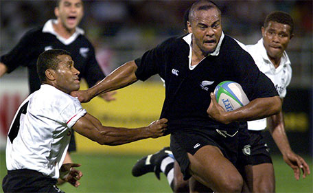 In this file picture taken on September 14, 1998, New Zealand rugby star Jonah Lomu (second right) pushes out of the tackle of Fijian captain Saimoni Rikoni (left) as New Zealand heads to victory and the gold medal in the rugby sevens competition at the XVI Commonwealth Games in Kuala Lumpur. (AFP)