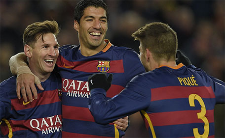 Barcelona's defender Gerard Pique (right) celebrates with Barcelona's Argentinian forward Lionel Messi (left) and Barcelona's Uruguayan forward Luis Suarez after scoring during the UEFA Champions League Group E football match FC Barcelona vs AS Roma at the Camp Nou stadium in Barcelona on November 24, 2015. (AFP)