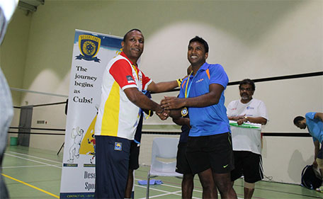 Men's Singles Open champion Asanka Nuwan Perera receiving the award from Aaron Vedhasinghe, badminton coach of Desert Cubs Cricket Academy. (Supplied)