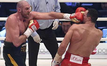 Britain's Tyson Fury (left) punches Ukraine's Wladimir Klitschko and in a world heavyweight title fight for Klitschko's WBA, IBF, WBO and  IBO belts in the Esprit Arena in Duesseldorf, Germany, Saturday, Nov. 28, 2015. (AP)