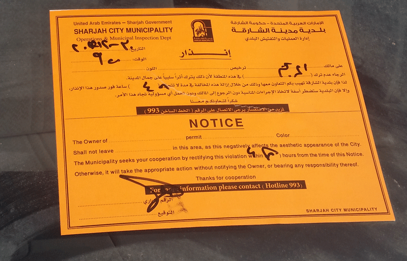 Sharjah Municipality's notice pasted on parked used cars in Abu Shagara. (Picture by Shaarly Benjamin)