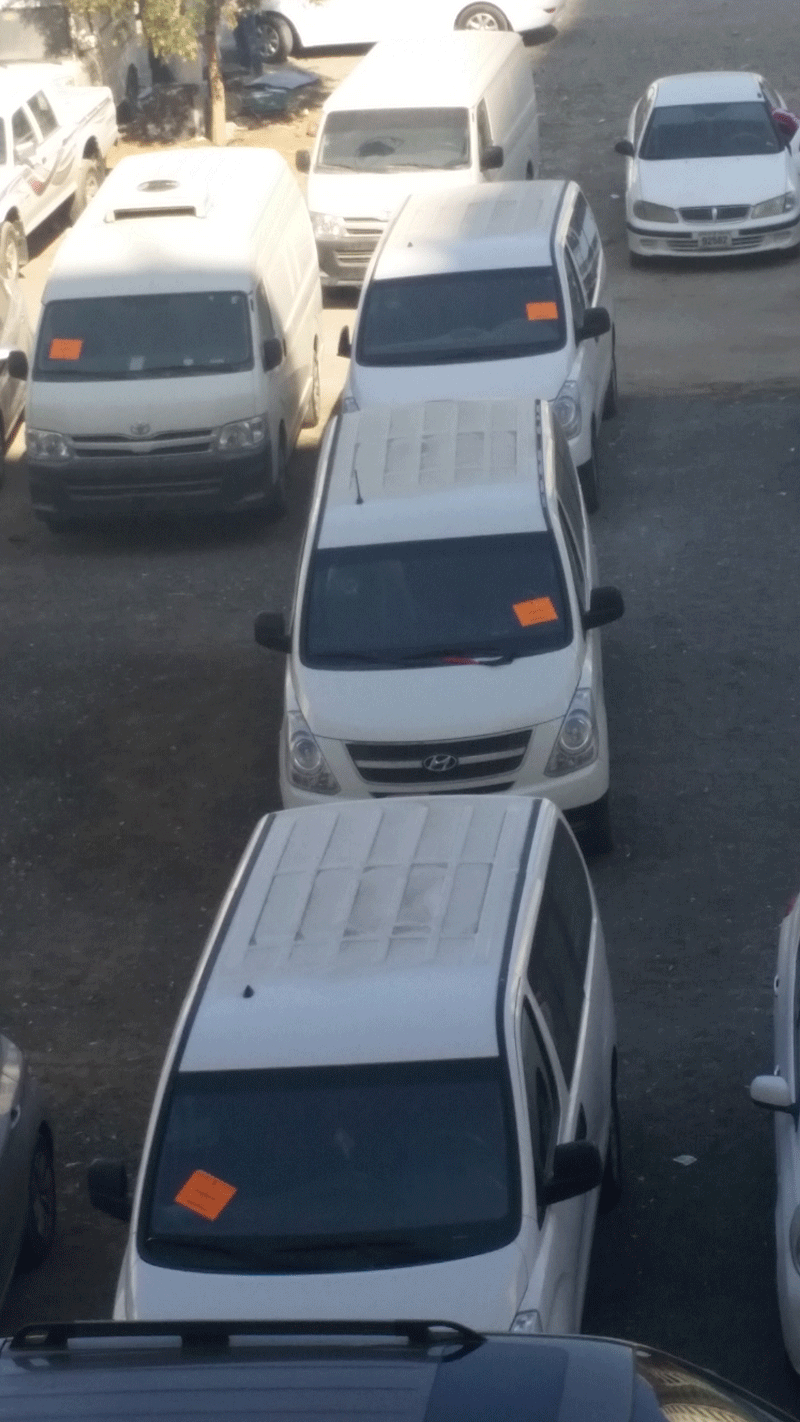 Used cars parked in Sharjah's Abu Shagara area, adorned with warning notice from the Municipality. (Picture by Shaarly Benjamin)