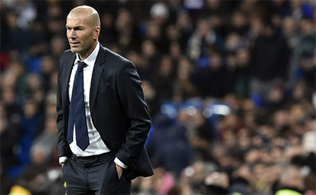 Real Madrid's French coach Zinedine Zidane looks at players during the Spanish league football match Real Madrid CF vs RC Deportivo La Coruna at the Santiago Bernabeu stadium in Madrid on January 9, 2016. (AFP)