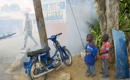 Dominican Air Force personnel fumigate various locations in Santo Domingo against the Aedes aegypti mosquito, vector of the Zika virus, on January 23, 2016.  The Dominican Republic said Saturday it has 10 confirmed cases of the mosquito-borne Zika virus, the ailment suspected of causing serious birth defects in newborns. (AFP)