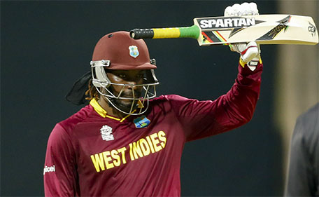 West Indies’ Chris Gayle raises his bat after scoring fifty runs against England during  their ICC World Twenty20 2016 cricket match at the Wankhede stadium in Mumbai, India, Wednesday, March 16, 2016. (AP)
