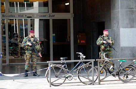 Belgian soldiers stand outside a closed entrance for the Midi railway station during high level security alert following the morning explosions in Brussels, Belgium, March 22, 2016.  REUTERS