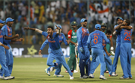 Indian cricketers celebrate after winning against Bangladesh in the ICC World Twenty20 2016 cricket match in Bangalore, India, Wednesday, March 23, 2016. (AP)