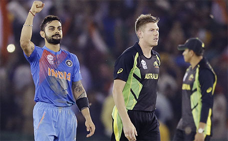 India's Virat Kohli (left) celebrates as he walks with Australia's James Faulkner after winning their ICC World Twenty20 2016 cricket match by six wickets in Mohali, India, Sunday, March 27, 2016. (AP)
