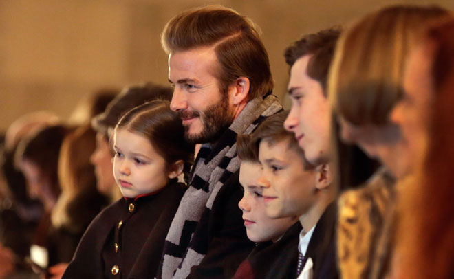 In this Feb. 14, 2016 photo, David Beckham and his children wait for the the Victoria Beckham Fall 2016 collection to be modeled during Fashion Week in New York (AP)