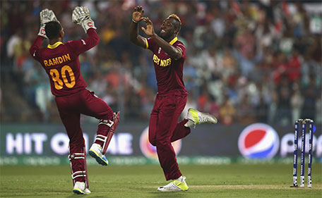 Andre Russell of the West Indies and Denesh Ramdin of the West Indies celebrate after taking the wicket of Alex Hales of England during the ICC World Twenty20 India 2016 Final match between England and West Indies at Eden Gardens on April 3, 2016 in Kolkata, India. (Getty Images)