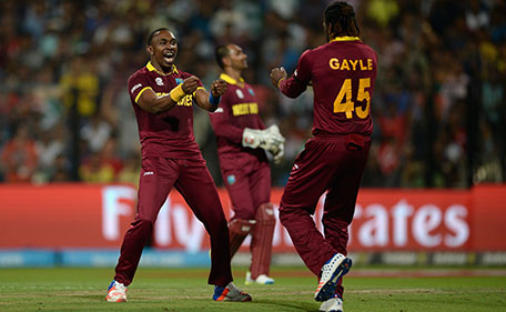 Dwayne Bravo of the West Indies celebrates with Chris Gayle after dismissing Ben Stokes of England during the ICC World Twenty20 India 2016 Final between England and the West Indies at Eden Gardens on April 3, 2016 in Kolkata, India. (Getty Images)
