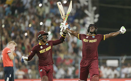 West Indies Carlos Brathwaite (right) celebrates with teammate Marlon Samuels after they defeated in England in the final of the ICC World Twenty20 2016 cricket tournament at Eden Gardens in Kolkata, India, Sunday, April 3, 2016. (AP)