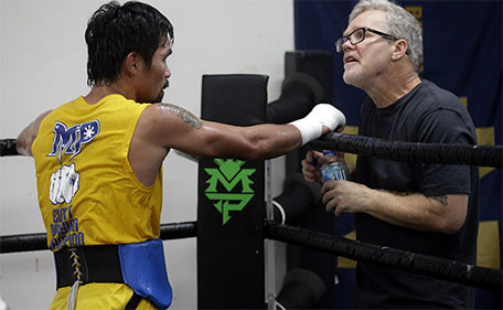 In this Monday, April 4, 2016, photo, boxer Manny Pacquiao works out with trainer Freddie Roach in front of reporters and photographers at the Wild Card gym in Los Angeles. (AP)
