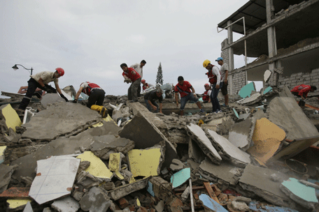 Volunteers search for survivors in the debris of buildings destroyed by an earthquake in Pedernales, Ecuador, Sunday, April 17, 2016. The strongest earthquake to hit Ecuador in decades flattened buildings and buckled highways along its Pacific coast, sending the Andean nation into a state of emergency (AP)