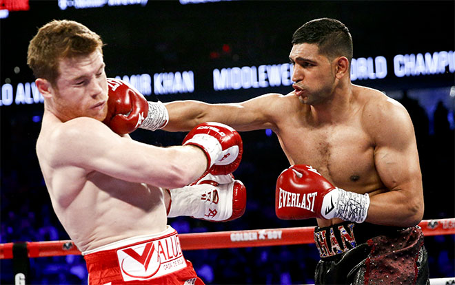 Canelo Alvarez, left, is hit by Amir Khan during their WBC middleweight title fight Saturday, May 7, 2016, in Las Vegas. (AP)