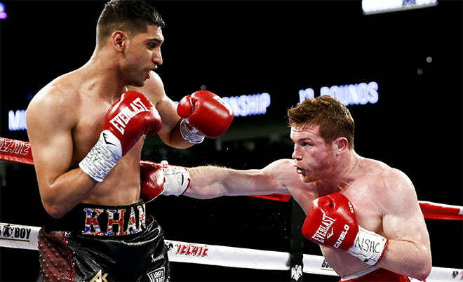 Canelo Alvarez (right) hits Amir Khan during their WBC middleweight title fight Saturday, May 7, 2016, in Las Vegas. (AP)
