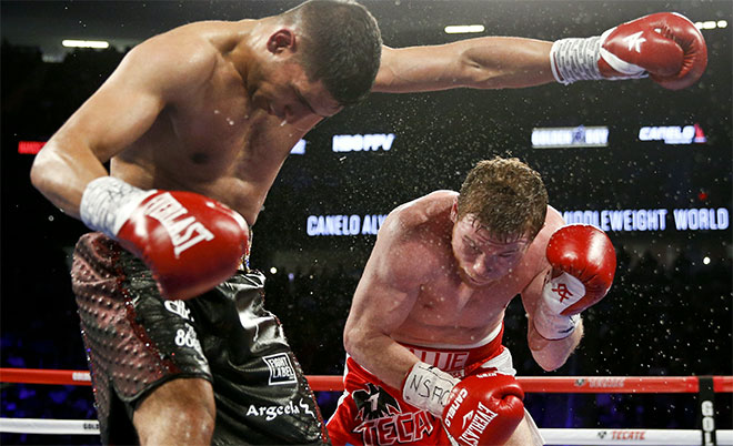 Canelo Alvarez (right) knocks down Amir Khan during their WBC middleweight title fight Saturday, May 7, 2016, in Las Vegas. (AP)