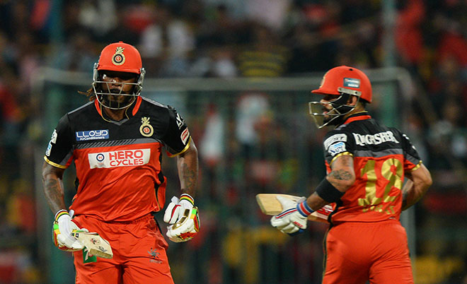 Royal Challengers Bangalore batsman Chris Gayle (left) and captain Virat Kohli run between the wickets during the 2016 Indian Premier League (IPL) Twenty20 cricket match between Royal Challengers Bangalore and Kings XI Punjab, at The M. Chinnaswamy Stadium in Bangalore on May 18, 2016. (AFP)