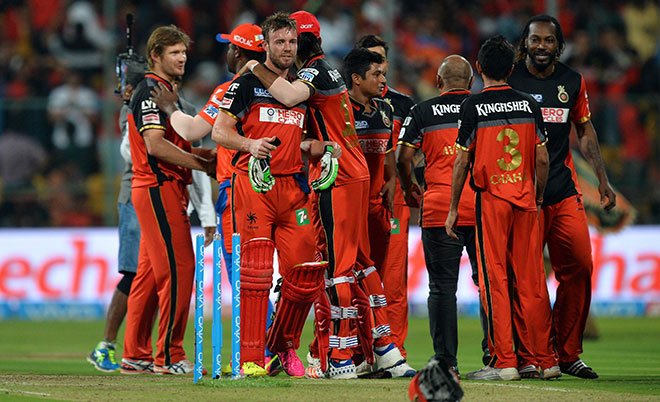Royal Challengers Bangalore players celebrate their victory over Gujarat Lions during the first qualifiers cricket match between Royal Challengers Bangalore and Gujarat Lions at The M. Chinnaswamy Stadium in Bangalore on May 24, 2016. (AFP)