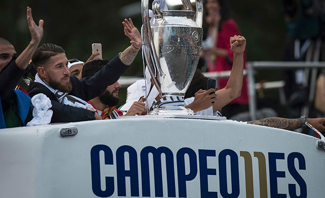 Real Madrid's defender Sergio Ramos celebrates holds up the trophy in celebration of the team's win on Plaza Cibeles in Madrid on May 29, 2016 after the UEFA Champions League final foobtall match between Real Madrid CF, Club Atletico de Madrid held in Milan, Italy. (AFP)