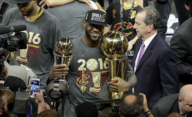 LeBron James #23 of the Cleveland Cavaliers holds the Larry O'Brien Championship Trophy and the Bill Russell NBA Finals Most Valuable Player Award after defeating the Golden State Warriors 93-89 in Game 7 of the 2016 NBA Finals at ORACLE Arena on June 19, 2016 in Oakland, California. (Getty)