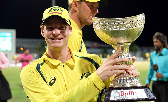 Australian cricket team captain Steven Smith poses with their winning trophy at the end of the final match of the Tri-nation Series between Australia and West Indies in Bridgetown on June 26, 2016. (AFP)